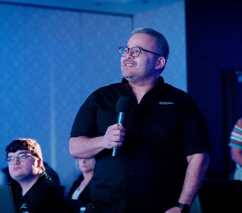 Manuel Ruiz speaking with a microphone on stage